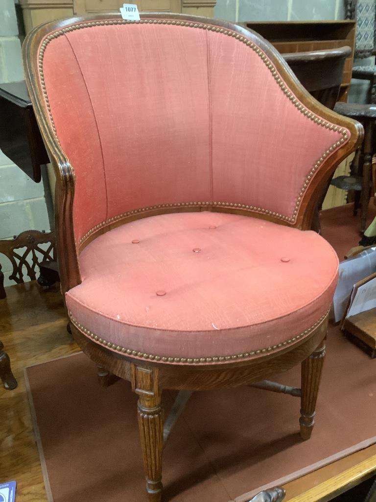 A Victorian oak revolving desk chair, by Waring & Sons Ltd of London, width 57cm